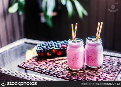 Fresh berry smoothies on mason jars