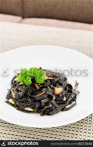 Fresh black aglio olio pasta with garlic and chilli