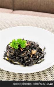 Fresh black aglio olio pasta with garlic and chilli