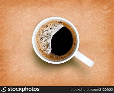 Fresh black coffee in a white cup on paper texture