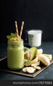 Fresh blended Banana and avocado smoothie with yogurt or milk in mason jar, healthy eating, superfood