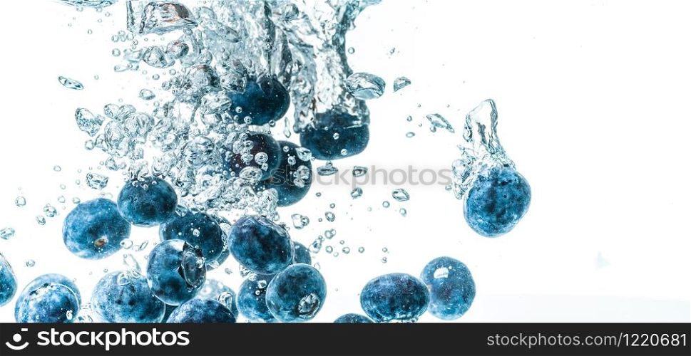 Fresh blueberries falling in water on white background. Fruits splashing into clear water. Antioxidant health concept. Fresh blueberries falling in water on white background. Fruits splashing into clear water.