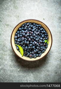 Fresh blueberries in a Cup. On the stone table.. Fresh blueberries in a Cup. On stone table.