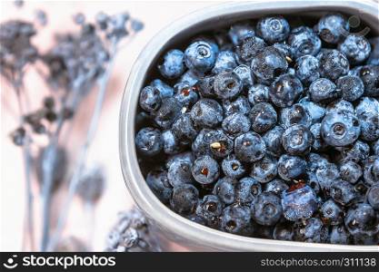 Fresh blueberries in a gray cup on pink background closeup.. Blueberries In A Cup