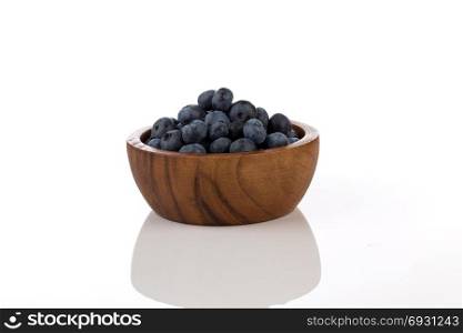 Fresh blueberries in bowl isolated on white background - close up