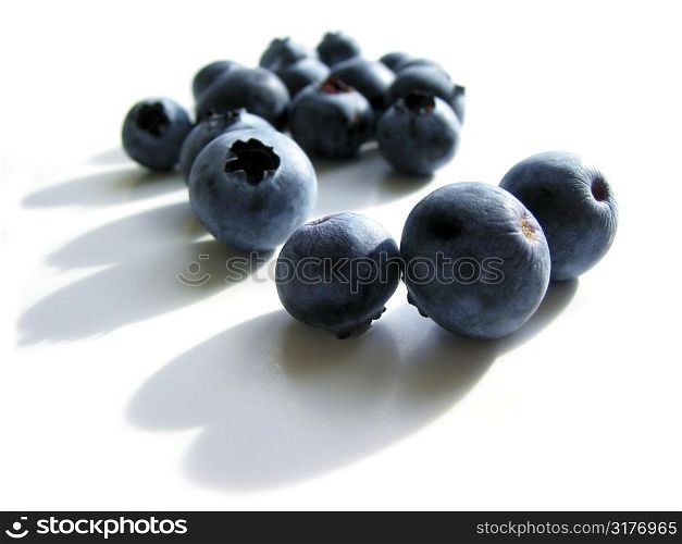 Fresh blueberries macro on white background with shadows