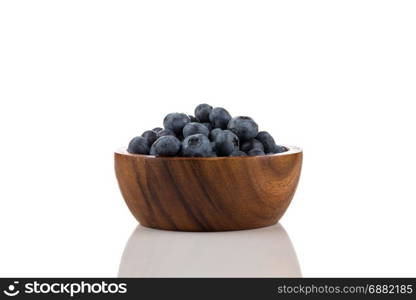 Fresh blueberries with water drops in bowl isolated on white background - close up