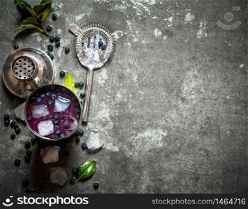 Fresh blueberry shake with ice. On a stone background.. Fresh blueberry shake with ice. On stone background.