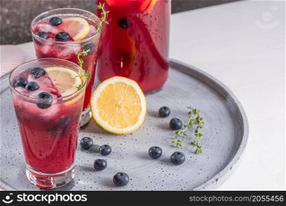 Fresh blueberry summer mojito cocktail. Blueberry lemonade or sangria on kitchen countertop