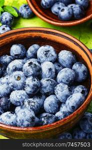 Fresh blueberry with drops of water in bowl. Berries blueberries or bilberry