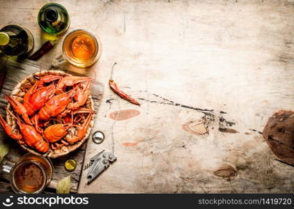 Fresh boiled crawfish with beer. On Wooden background.. Fresh boiled crawfish with beer.