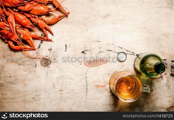 Fresh boiled crawfish with beer. On Wooden background.. Fresh boiled crawfish with beer.