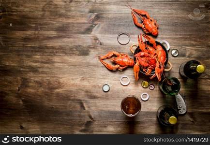 Fresh boiled crawfish with beer. On Wooden background.. Fresh boiled crawfish with beer.
