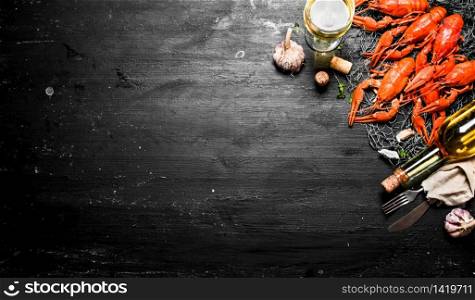 Fresh boiled crawfish with garlic and white wine. On a black chalkboard.. Fresh boiled crawfish with garlic and white wine.