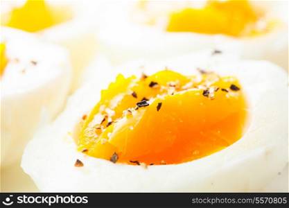 Fresh boiled eggs with spices close up