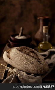 Fresh bread and table cloth at wooden table. Bakery still life and bread on wood tabletop