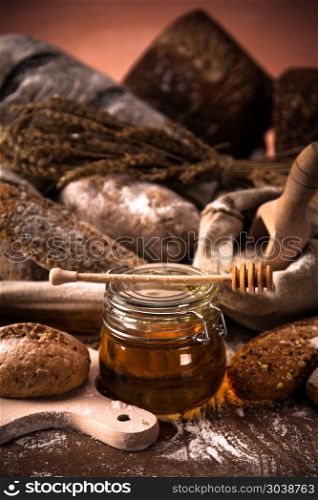 Fresh bread and wheat on the wooden table