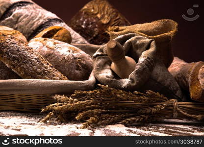 Fresh bread and wheat on the wooden table