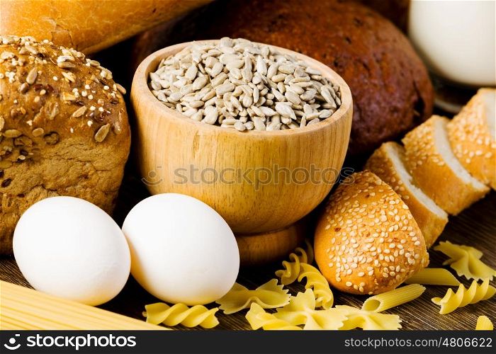 Fresh bread, eggs and macaroni on table