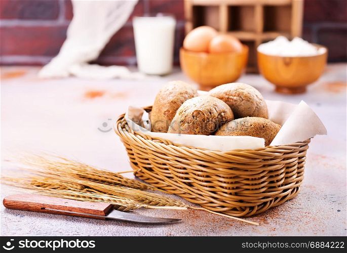 fresh bread in basket and on a table