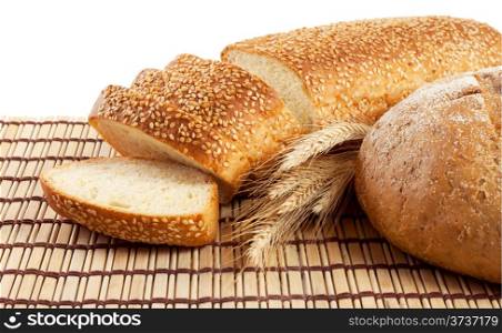 Fresh bread on a straw mat isolated on white background