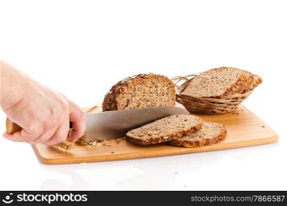 Fresh bread. Slicing Bran Bread on a Cutting Board. hands cutting bread on wooden board