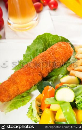 fresh breaded chicken breast roll and vegetables,with lager beer and fresh vegetables on background
