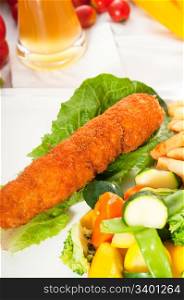fresh breaded chicken breast roll and vegetables,with lager beer and fresh vegetables on background