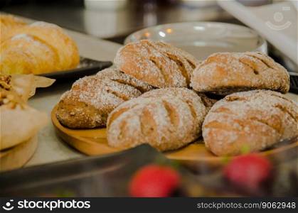 fresh breads on wooden plate