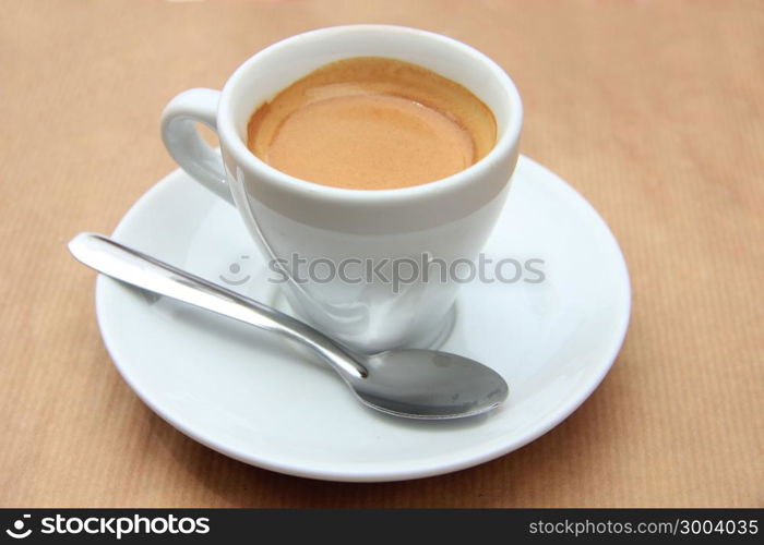 Fresh brewed espresso coffee in a white cup