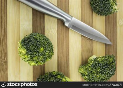 Fresh broccoli. Fresh broccoli on wood with knife.