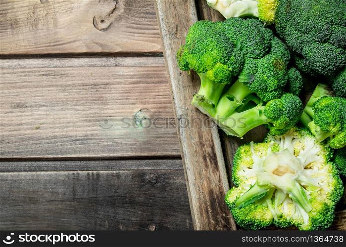 Fresh broccoli in a wooden box. On a wooden background.. Fresh broccoli in a wooden box.