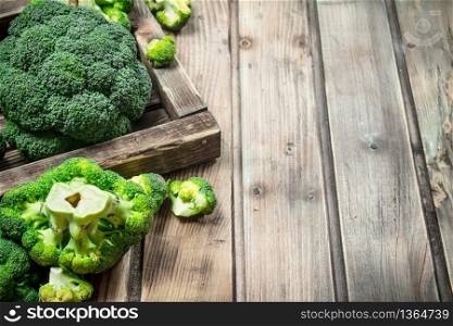 Fresh broccoli in a wooden box. On a wooden background.. Fresh broccoli in a wooden box.