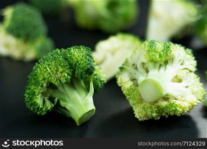 Fresh broccoli on black background.