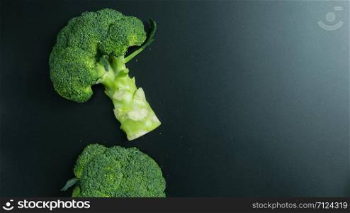 Fresh broccoli on black background. top view