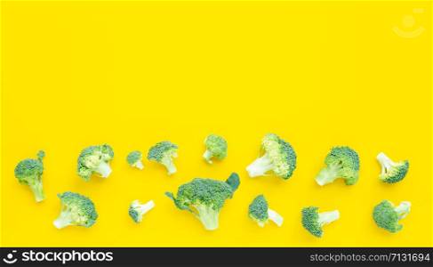 Fresh broccoli on yellow background. Copy space