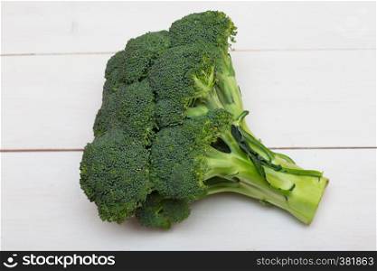 fresh broccoli stem on a white wooden background
