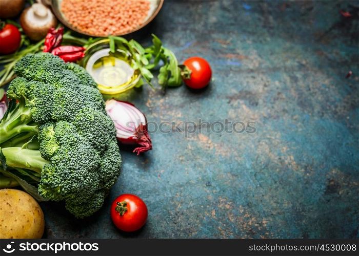 Fresh broccoli , various vegetables, red lentil and ingredients for cooking on rustic wooden background, border. Healthy food or diet eating concept.