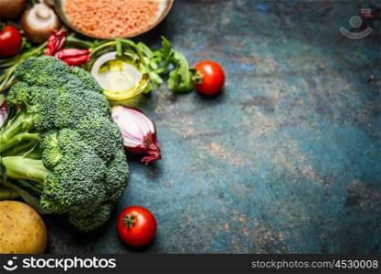 Fresh broccoli , various vegetables, red lentil and ingredients for cooking on rustic wooden background, border. Healthy food or diet eating concept.