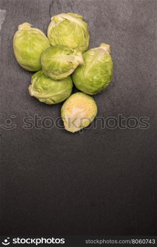 Fresh brussel sprouts on slate. Top view with copy space.