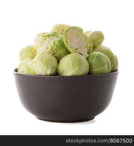 Fresh brussels sprouts on brown ceramic bowl isolated on white background.