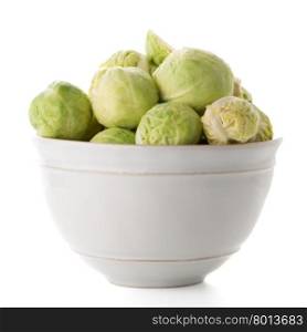 Fresh brussels sprouts on white ceramic bowl isolated on white background.