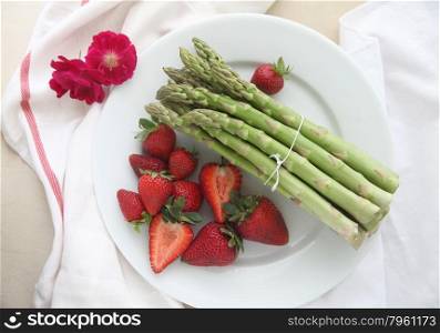 fresh bunch of asparagus with strawberries and flowers
