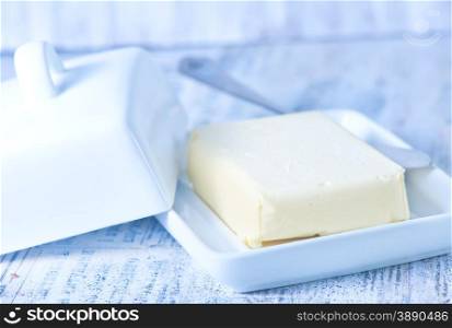 fresh butter on plate and on a table