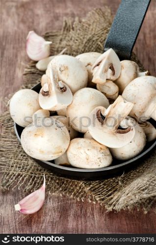 Fresh button mushrooms in skillet, selective focus
