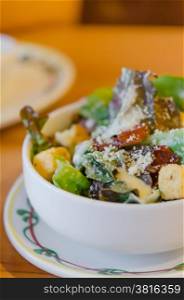 fresh caesar salad . fresh caesar salad on bowl with parmesan cheese