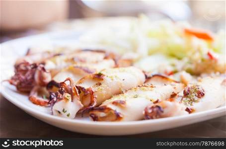 Fresh calamari served in an old Italian restaurant (Tuscany). Daylight.