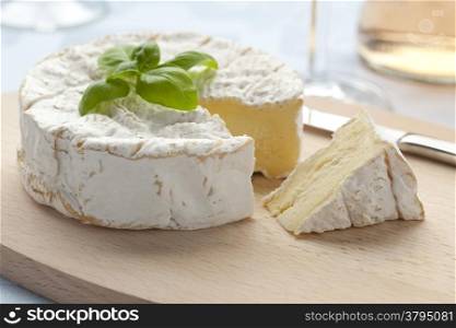 Fresh Camembert cheese and a slice
