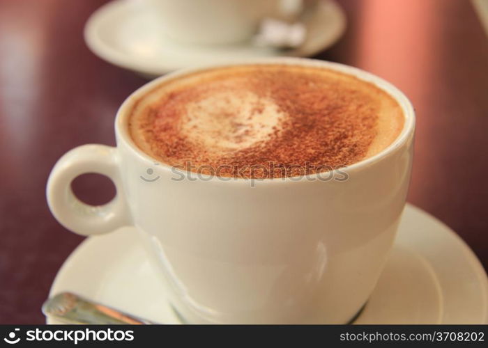 Fresh cappuccino in a white cup