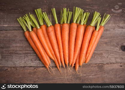 fresh carrot bunch on grungy wooden background